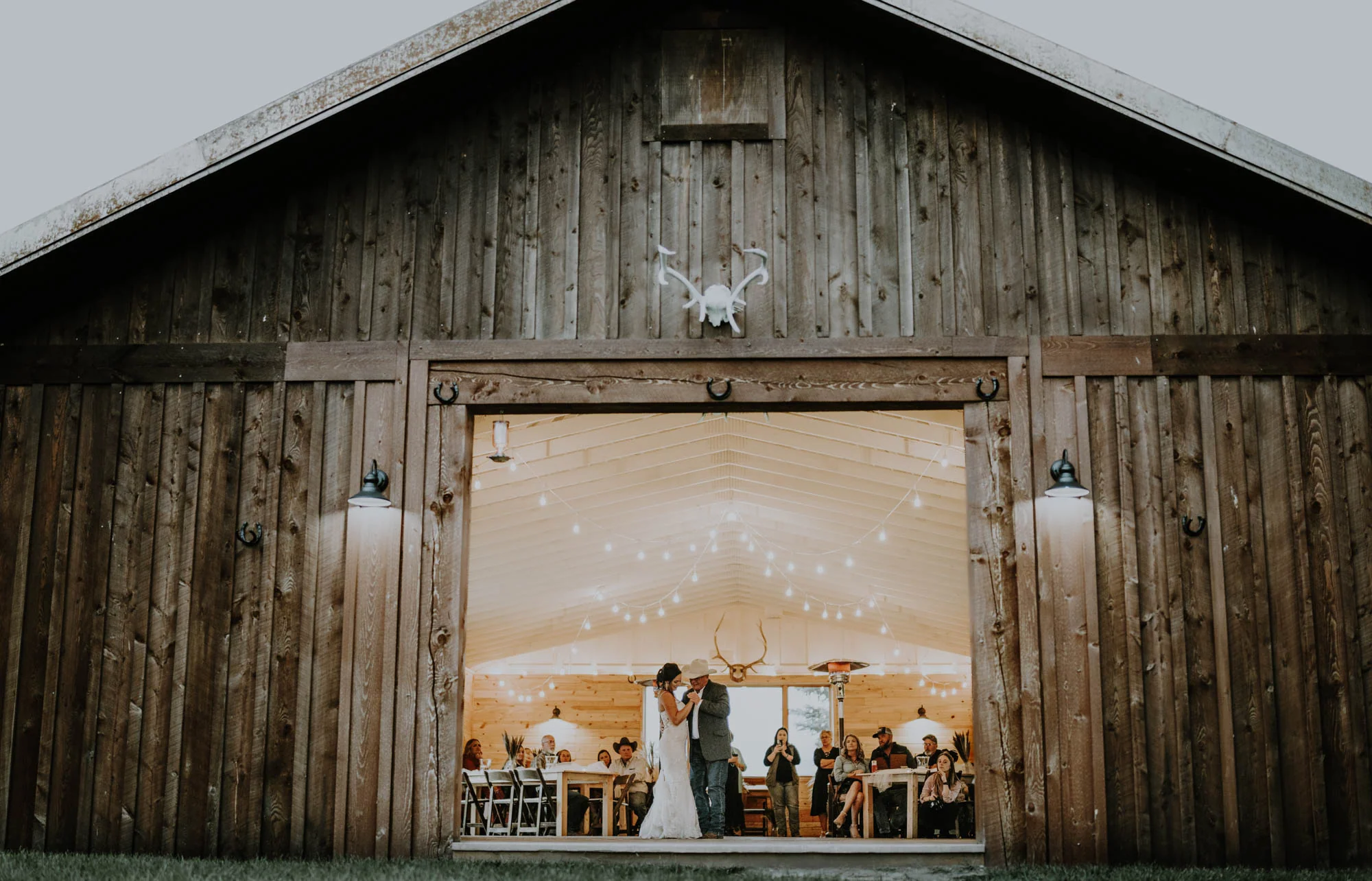 Wedding reception through an open barn doorway