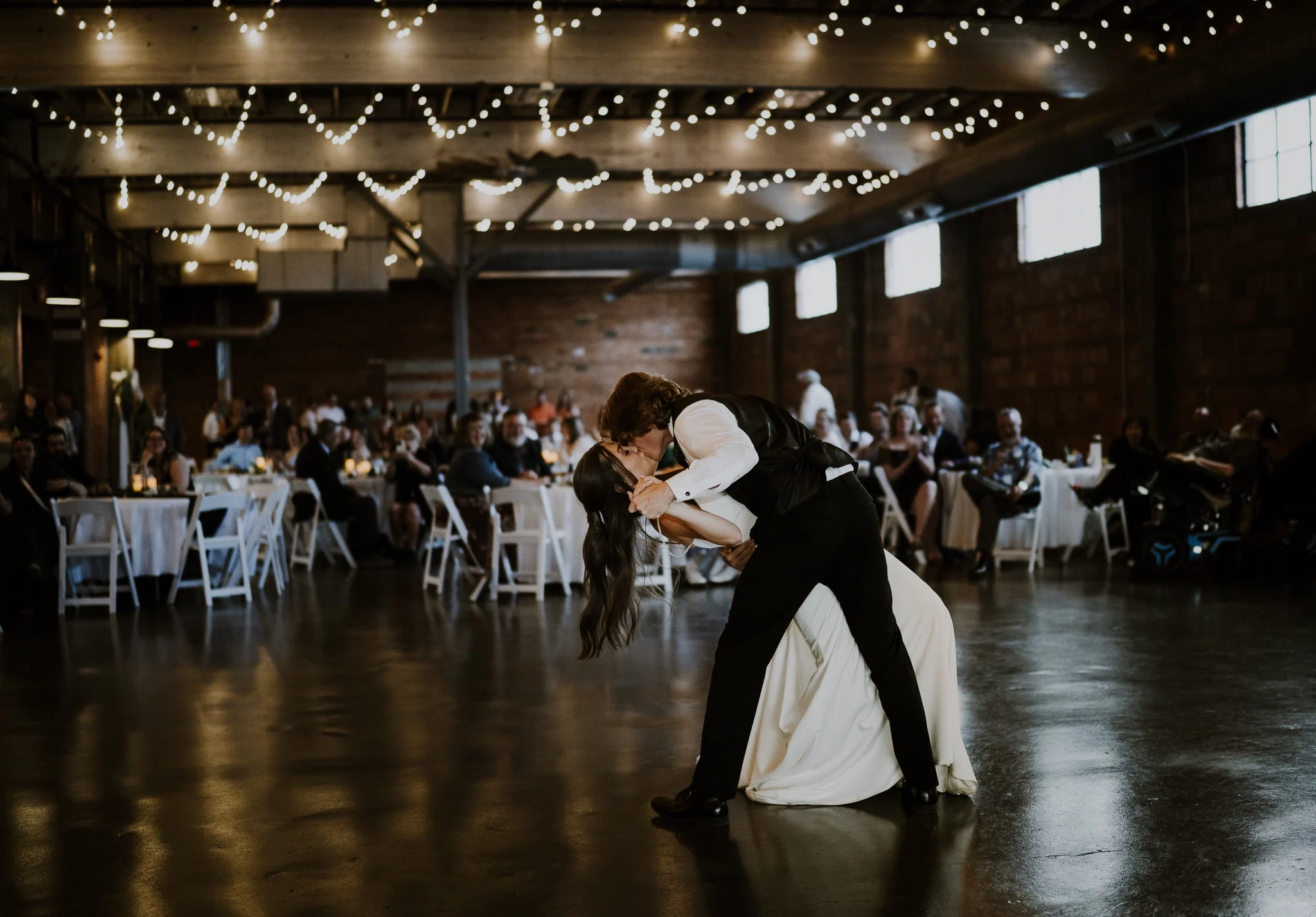 A dramatic first-dance dip at the wedding reception